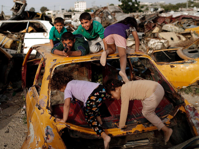 Palestinian children play amidst wrecked cars in an impoverished area of the southern Gazan city of Khan Yunis. Since the blockade of the Gaza strip following Hamas’ takeover, the economy has declined, the import of necessary materials has been difficult and the strip has come under repeated attack by Israeli forces.