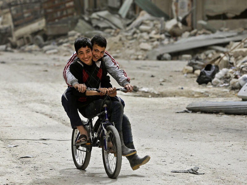 Two children playing on their bikes in the ruins of the Shaar district, Aleppo. The battle for Aleppo, which ended with the Syrian government’s recapture of city in December 2016, was one of the most devastating battles in the Syrian civil war. It left around 31,000 people dead, displaced thousands and caused severe damages to the old city.