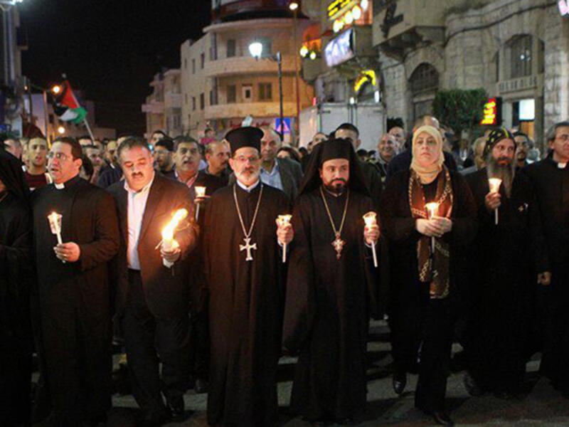 Palestinian Muslims and Christians marched in a candlelight vigil in Gaza in November 22, 2012. They gathered together in solidarity after the death of a Christian member of the Palestinian Legislative Council. 