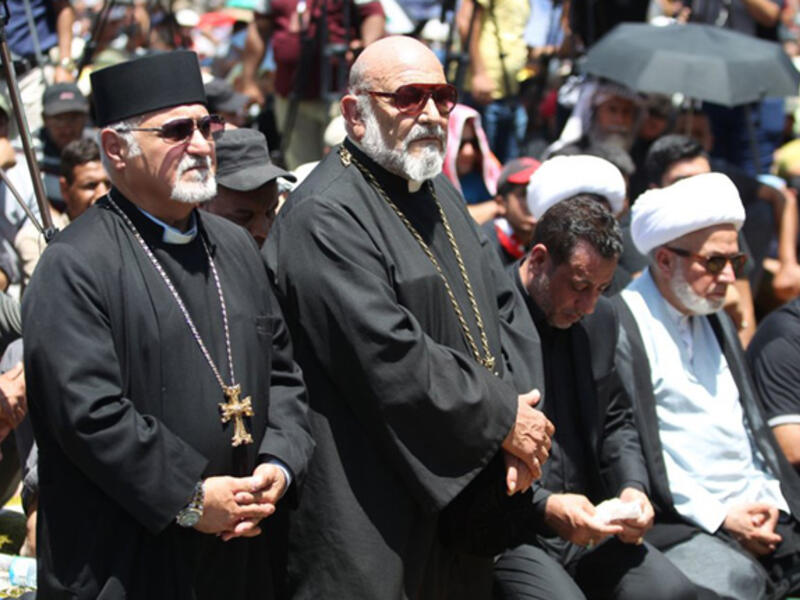 Iraqi Christians take part in Friday prayer in the Karrada neighborhood of Baghdad in July 2016, after a massive bombing killed nearly 300 people during Eid al-Fitr after Ramadan. The suicide attack targeted Shia worshippers, but killed Iraqis of all faiths and walks of life. 