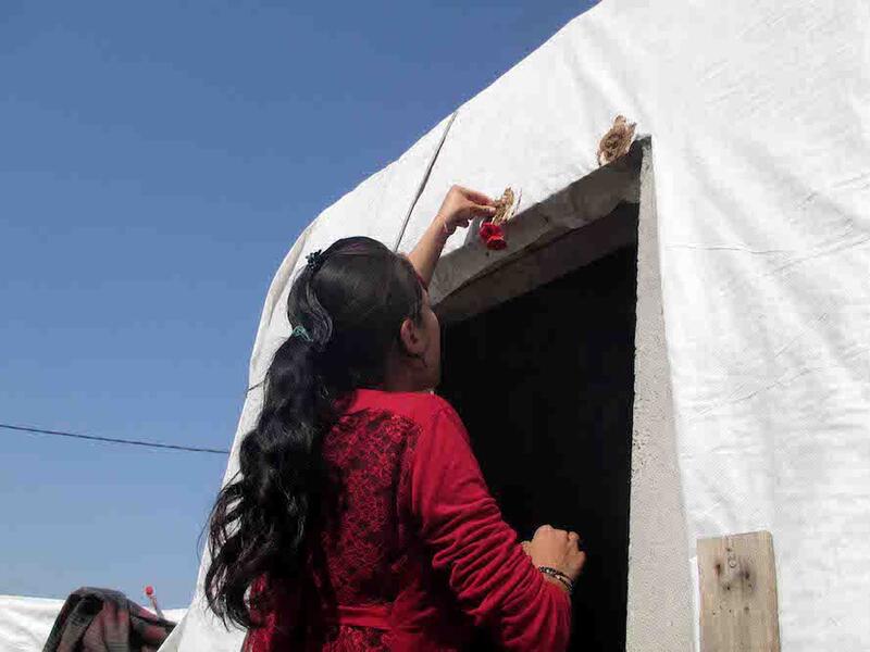 Broken egg shells, mud and anemone flowers are placed above the door of Yazidi homes, providing its residents with luck and fertility for the following year. 