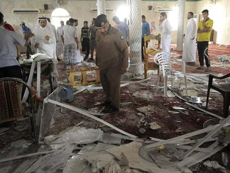 Saudi police survey the aftermath of the Al-Asir mosque bombing in August 2015. (AFP/File)
