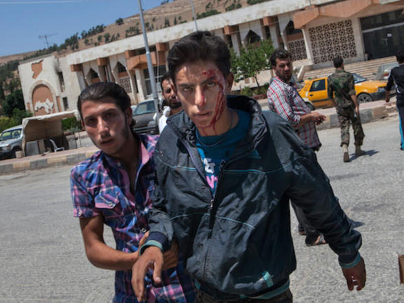 A wounded Syrian man arrives to receive treatment at Bab al-Hawa hospital near Syria's rebel-controlled border with Turkey (Source: AFP/DANIEL LEAL-OLIVAS)