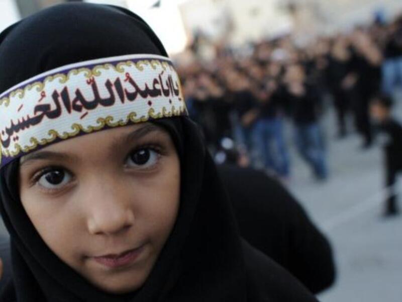 Ashura derives from 'tenth': It is a holy day for Islam marked on the 10th of 'Muharram', the first month of the Islamic lunar 
calendar. Muharram represents a period of mourning for a historical grievance in Shia Islam,
culminating Ashura. This child displays a classic lament for the revered martyr: 'O Hussein you were the father of Abdullah'.