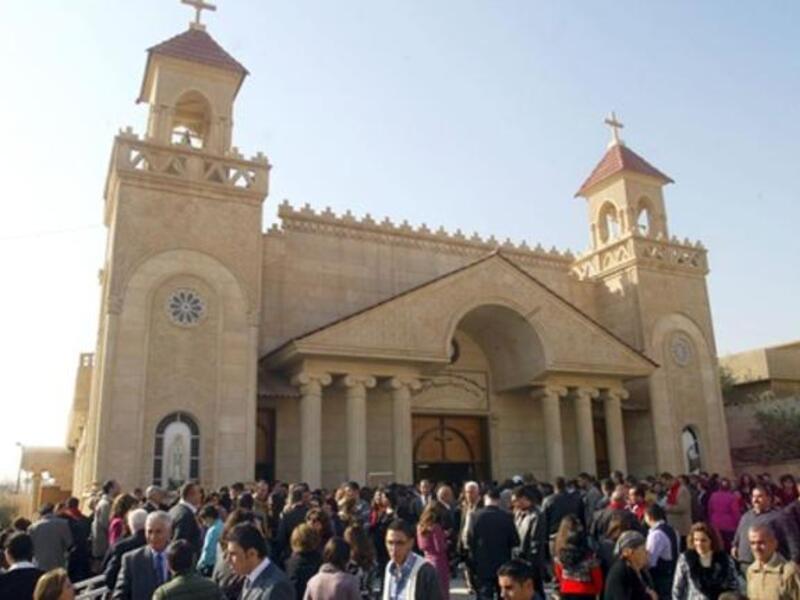 Iraqi Chaldean Catholics gather ouside the Cathedral of Kirkuk following Christmas day mass in northern Iraq.