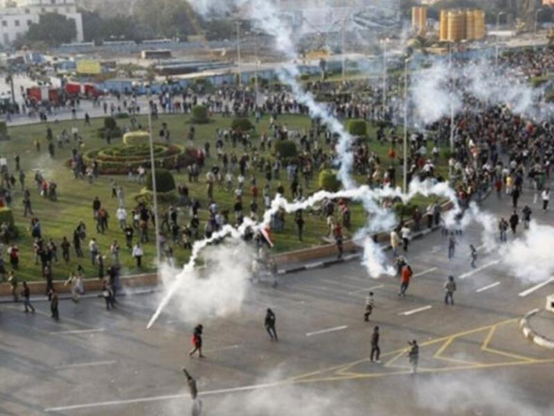 Tear gas smoke fired by Egyptian police is seen as demonstrators gather in central Cairo.