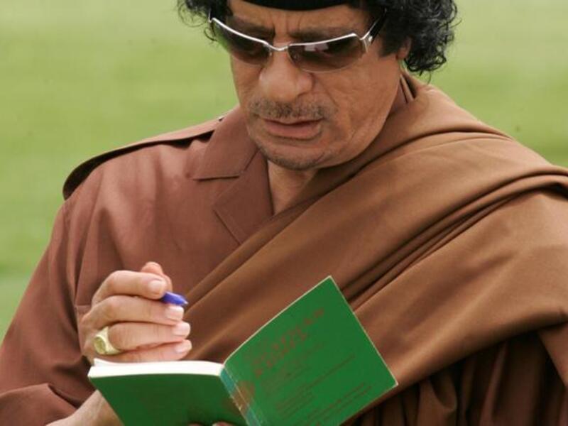 Gaddafi signs "The Green Book". The book is written by Gaddfi himself, contains controversial ideas about women, and it was first published in 1975.