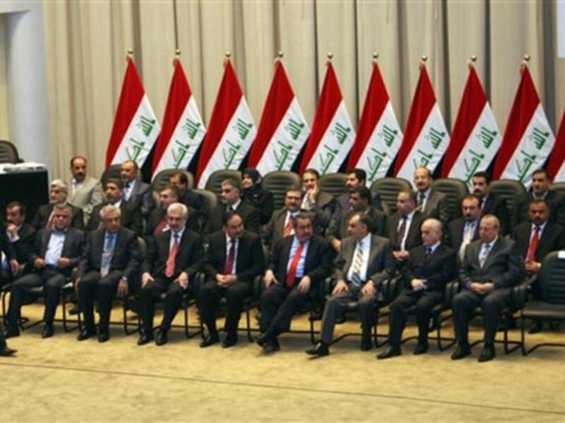 Iraqi Prime Minister walks towards his seat past members of his new cabinet during a parliamentary session in Baghdad in which lawmakers unanimously approved the new government to be headed by the incumbent Shiite premier.