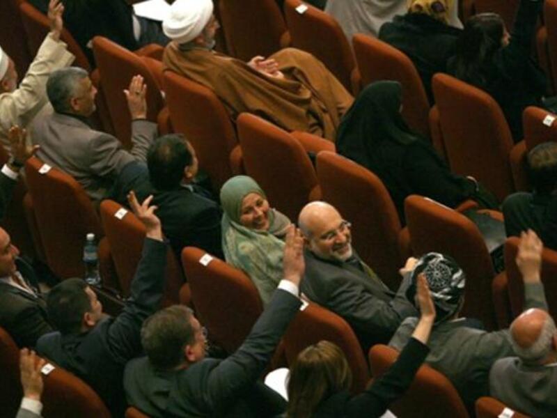 Iraqi MPs vote in parliament in Baghdad as lawmakers gave Prime Minister Nuri al-Maliki's government a vote of confidence and adopted a 43-point program aimed at liberalising the economy and fighting terrorism.