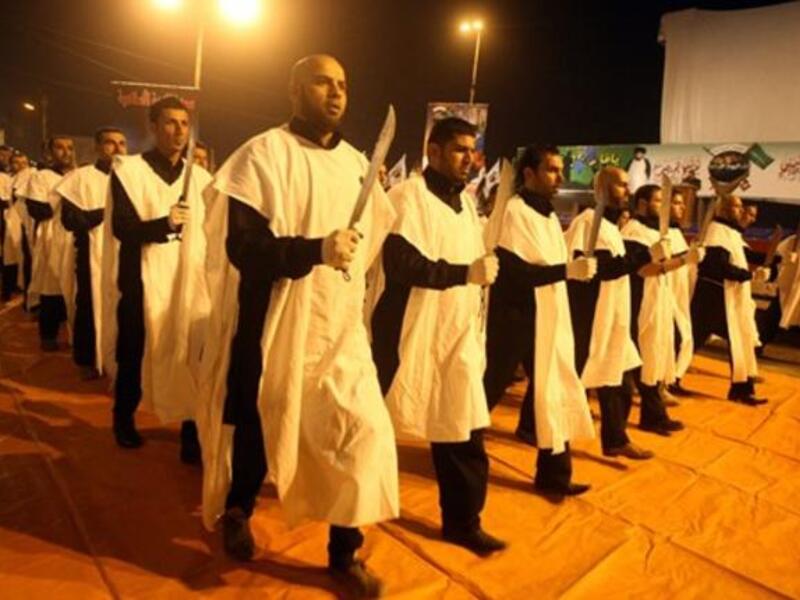 Members of The Promised day brigade, the military wing of Sadr movement, march during a parade marking the second festival of the Islamic resistance in Baghdad impoverished district of Sadr City.