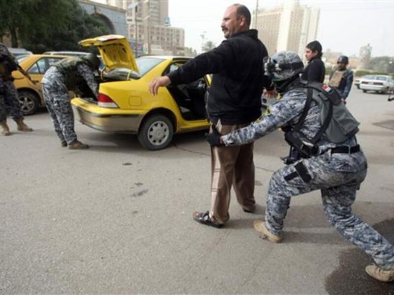 Iraqi troops implement strict security measures on main roads in Baghdad,as Shiite Muslims prepare to mark the religious event of Ashura on December 17 at the end of ten days of mourning for in commemoration of the 7th century killing of Imam Hussein.