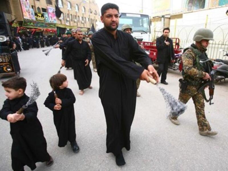 Iraqi soldiers protect a Shiite Muslim Ashura procession in the shrine city of Karbala in central Iraq.