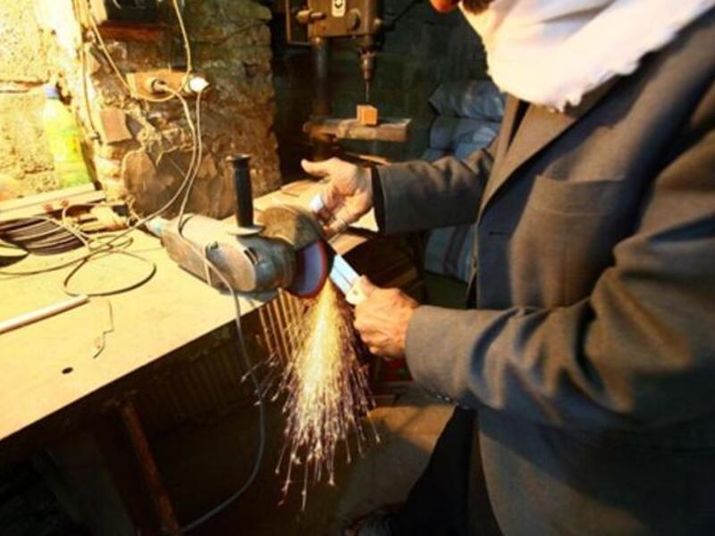 An Iraqi vendor sharpens knives used for the ritual of self flagellation by Shiite Muslims during the 10 mourning period of Ashura in the shrine city of Karbala.