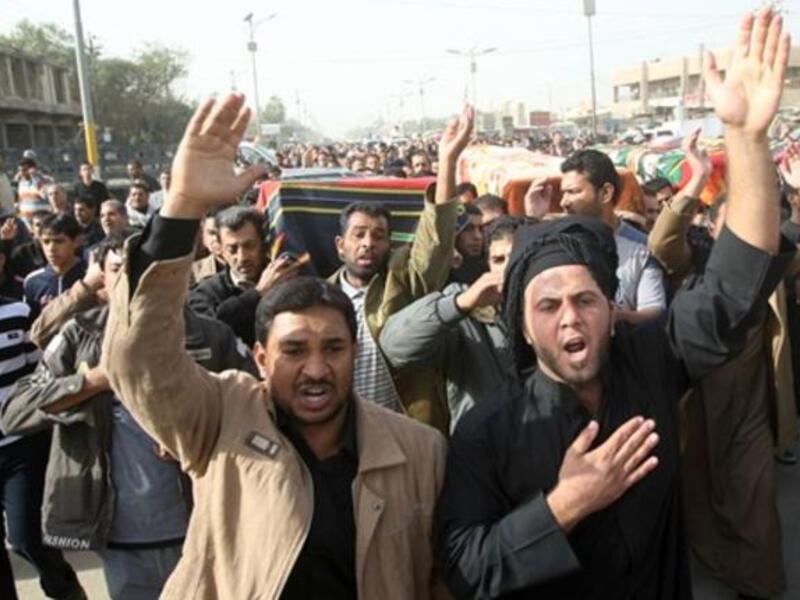 Iraqi Shiite Muslims carry the coffins of people killed in a bomb blast that targeted a convoy of pilgrims in the Ghazaliyah district of Baghdad.