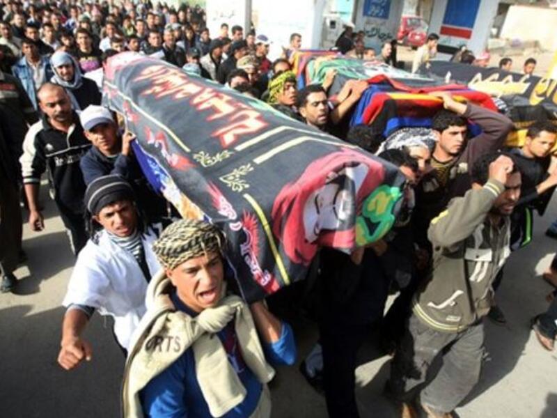 Iraqi Shiite Muslims carry the coffins, of people killed in a bomb blast that targeted a convoy of pilgrims in the Ghazaliyah district of Baghdad as Shiite Muslims prepare to mark the religious event of Ashura.