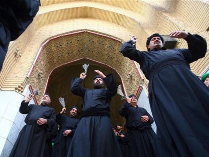 Shiite Muslim men flagellate themselves with chains, as they entering Imam Hussein's tomb where He was buried, in the shrine city of Karbala.
