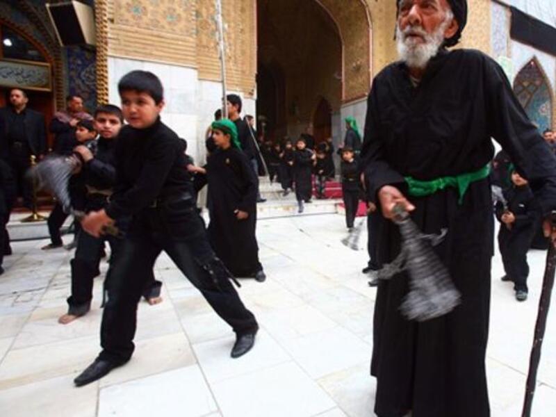 Shiite Muslim men and lads flagellate themselves with chains in an Ashura ritual in the shrine city of Karbala in central Iraq.