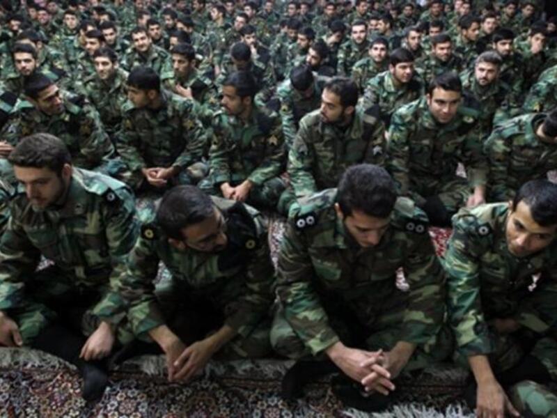 Iranian soldiers sit during the ceremony.