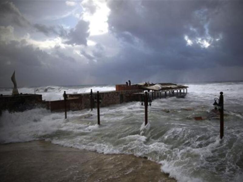 High waves flood a fish restaurant on the Mediterranean coast of the northern Lebanese port of Byblos.