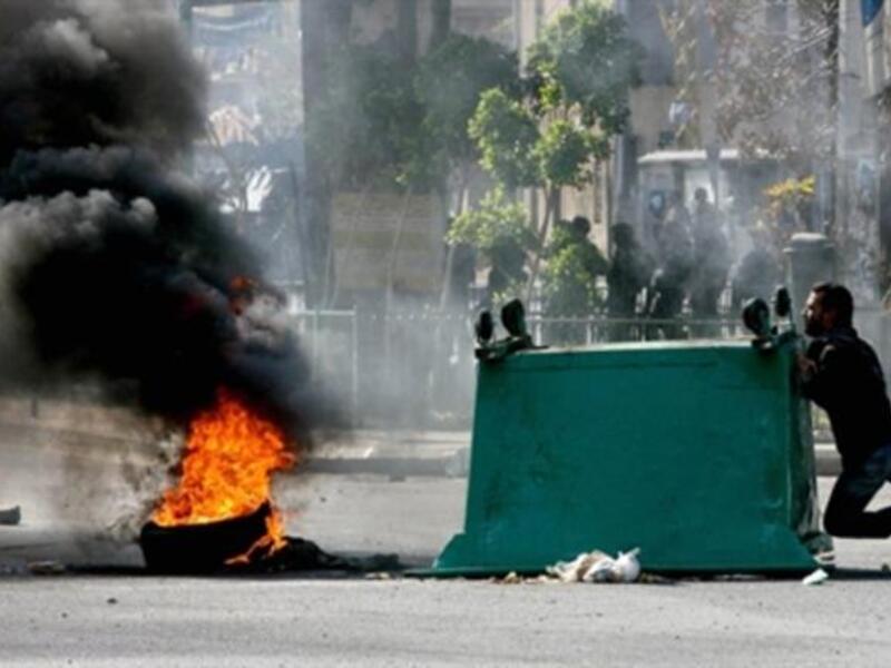 A garbage skips is pushed along a street as supporters of the Future Movement gather in a neighborhood in the capital Beirut during a demonstration in support of the caretaker prime minister Saad Hariri.