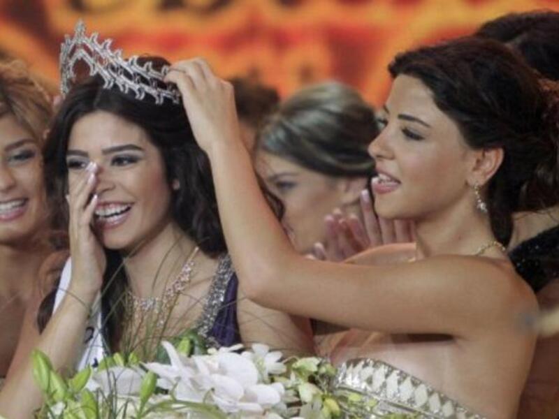 Miss Lebanon 2010 Rahaf Abdallah (R) crowns Yara Khoury Mikael after winning the Miss Lebanon Pageant 2011 beauty contest.