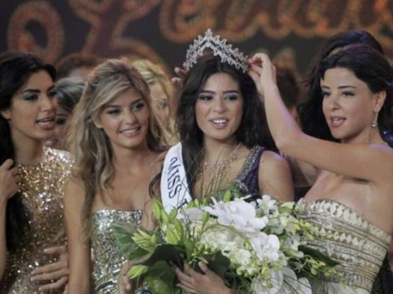 Miss Lebanon 2010 Rahaf Abdallah (R) crowns Yara Khoury Mikael Miss Lebanon 2011 beauty contest.
