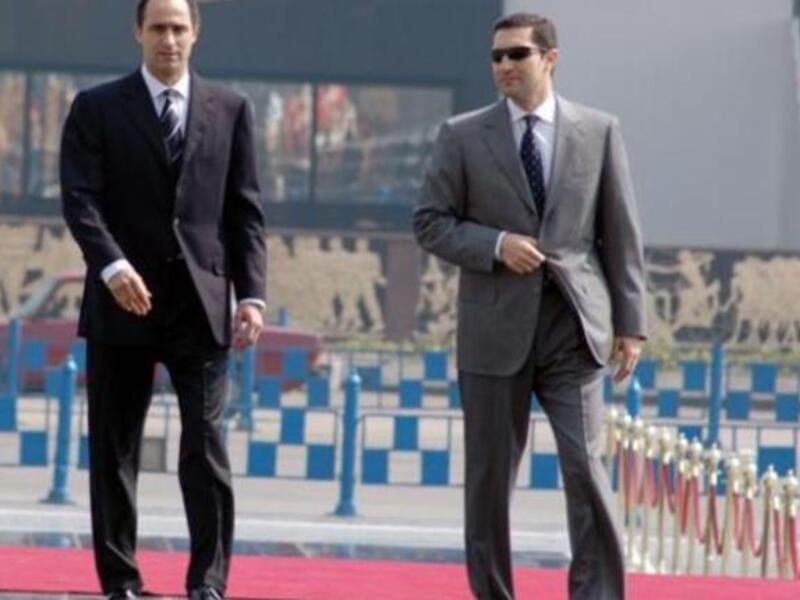 Ala’a Mubarak (R), clad in white suit, not the zebra striped outfits we expect, nor the orange jumpsuits of other notorious jails. Brothers now housed in Tora jail. Mock-called Tora-Bora in ref to the Afghani caves.