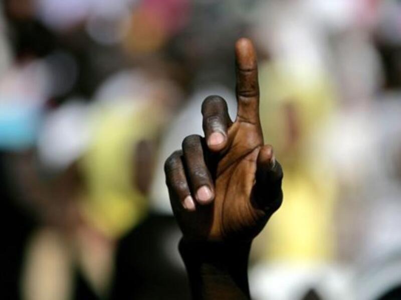 A Sudanese student points in the air during a protest against the visit of Darfur mediators from Qatar and the UN outside the University of Zalingei in western Darfur.