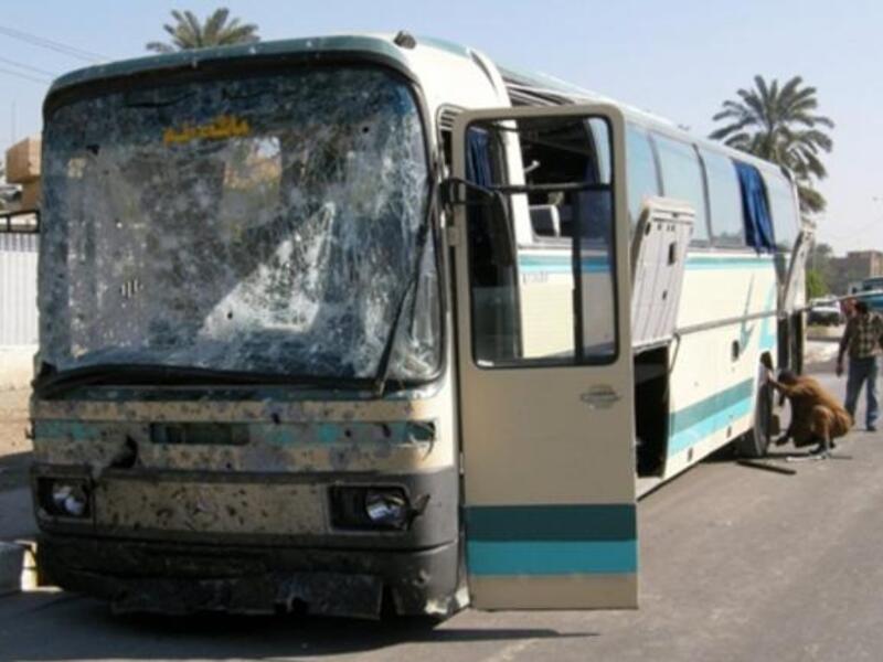 IRAQ: Iraqis inspect a damaged bus that was hit by a car bomb explosion as it was carrying Iranian pilgrims in the mostly Shiite north Baghdad neighborhood of Kadhimiyah, January 23, 2011.