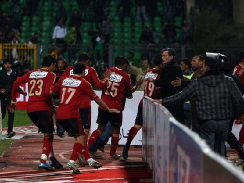 Al-Ahly players abandon the pitch as Al-Masry fans rush to the locker-room. The 'big team'
face-off with a local home team, underdog, victor-  Al Masry - got ugly when hardcore 'groupies' in Egypt known as 'Ultras' kicked off. These fanatic followers of fanclubs, introduced grievances from Tahrir, Masepro,& propaganda into friendly football. 
