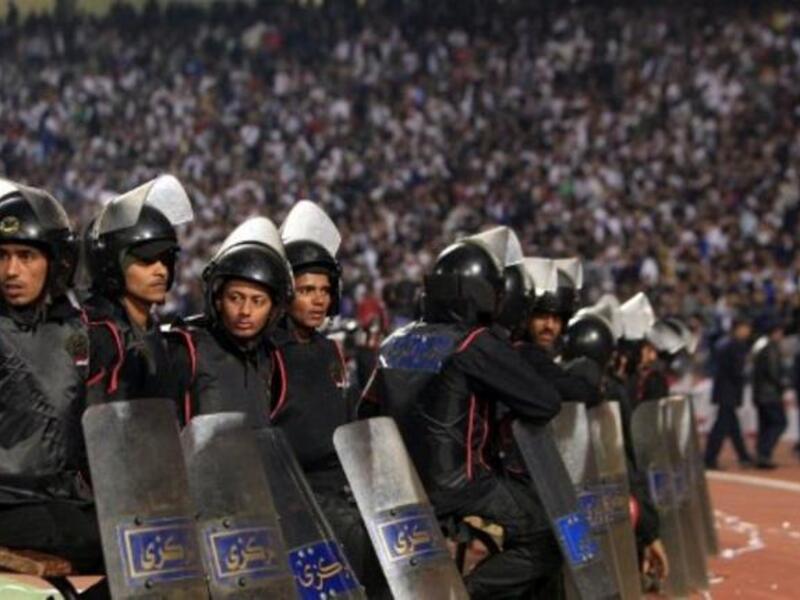Egyptian riot police: stand guard in Cairo Stadium during the first half of a match between
Zamalek and Ismaili clubs in Cairo. The second half was suspended after events from Port Said filtered over. There was much criticism of the security and police who left their post and bailed as things got out of control. 