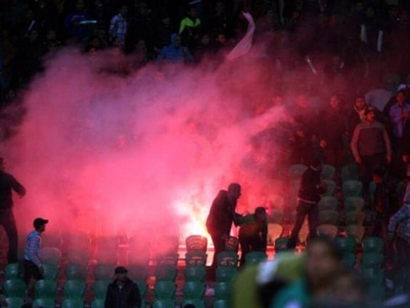Flares thrown in the stadium during clashes that erupted after a football match between
Egypt's Al-Ahly & Al-Masry teams. As taken from the Arabic for 'crude weaponry'- 'white weapons'- were used for most 
of the killings-- pocket knives, stones & bare hands. Sources say an al Masry fanatic (Abo Alarabi) rushed into the stadium
with a taser gun. 