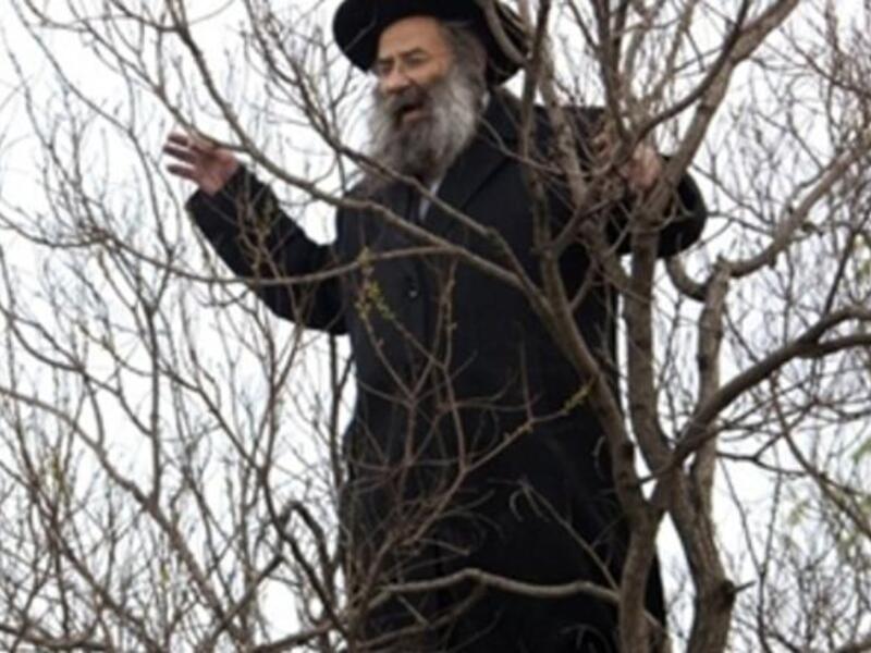 An Ultra Orthodox Jewish man shouts slogans as he watches the scene of an explosion next to a bus near Jerusalem's central bus station.