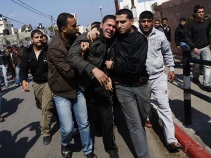 Palestinian mourners comfort each other during the funeral procession of Mohammed Atya Al-Harazine, a member of the Al-Quds Brigade, the armed wing of the Islamic Jihad, in Gaza.