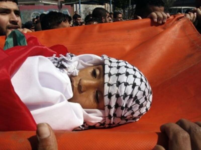 Palestinian mourners carry the body of 11-year-old Mohammed al-Helu during a funeral in Gaza City.