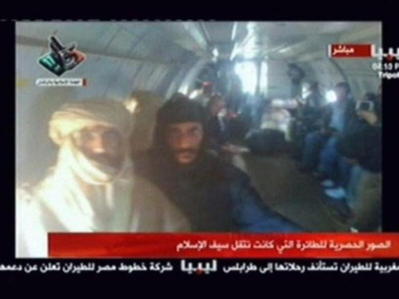 A shadow of the 'modern' accomplished well-traveled Saif who was mostly seen in Western business attire -- a suit and tie. Unlike his father who was known not to travel without his trusty Bedouin tent get-up and moreover tent-like tribal dress. Captured, Saif al-Islam appears the part of the loyal son to his theatrically attired murdered father.