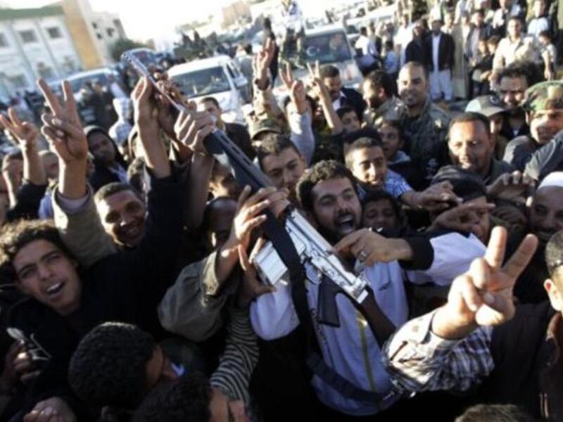 Brandishing a gun claimed as al-Islam's, the jubilant crowds hail a victory in their struggle for power & a clean break from the old Gaddafi family dictatorship. Empowered & liberated, they applaud their seizure of the last 'fighting' flesh of Gaddafi. Most are happy to hand him over to international courts, while he refuses to recognize the ICC.