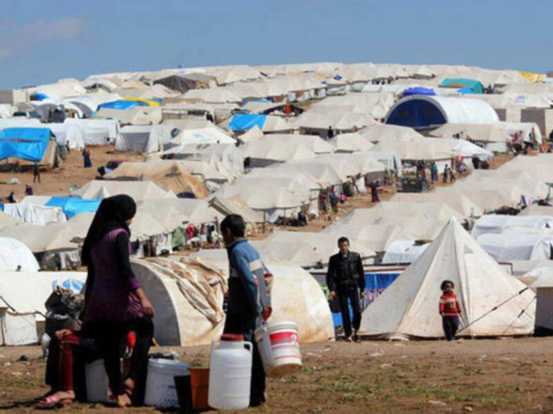 Syrians at a Turkish refugee camp (Getty)