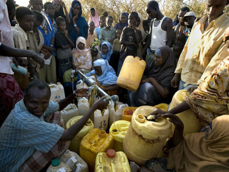 Somali refugees wait for water, Dadaab, Kenya. The three camps at Dadaab, which were designed for 90,000 people, now have a population of about 250,000 Somali civilians (AFP)