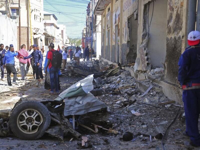 Somali security forces and civilians gather at the scene of a car bomb attack in Mogadishu on May, 15, 2017 (Mohamed Abdiwahab/AFP)