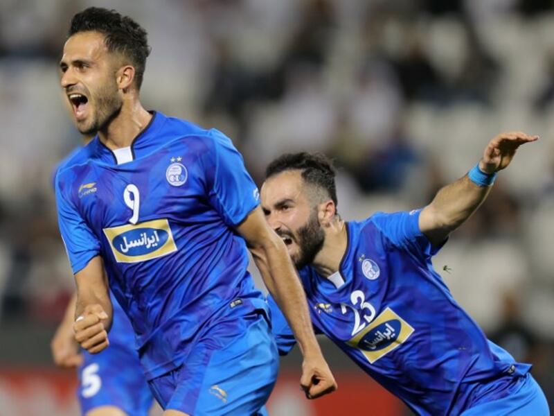 Esteghlal FC's Iranian forward Ali Ghorbani (L) celebrates with his teammates after scoring a goal against Al-Rayyan SC during their Asian Champions League football match at Jassim Bin Hamad Stadium in the Qatari capital Doha on February 13, 2018.
KARIM JAAFAR / AFP