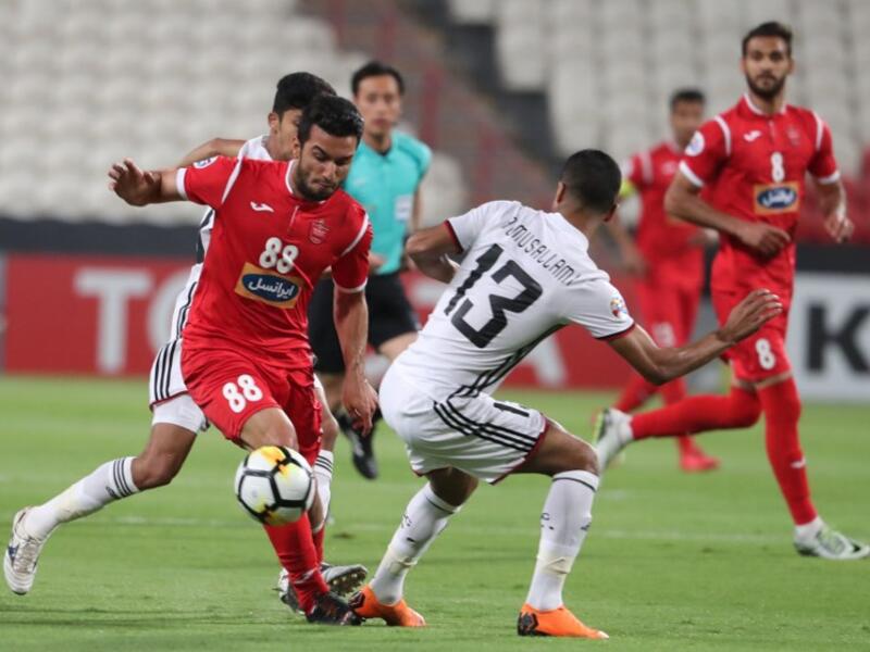 UAE's Al-Jazira club player Mohammad Al-Musalami (C) and Iran's Perspolis FC club player Siamak Nemati (L) vie for the ball during their AFC Champions League football match at the Mohammed Bin Zayaed Stadium in Abu Dhabi on May 7, 2018.
KARIM SAHIB / AFP