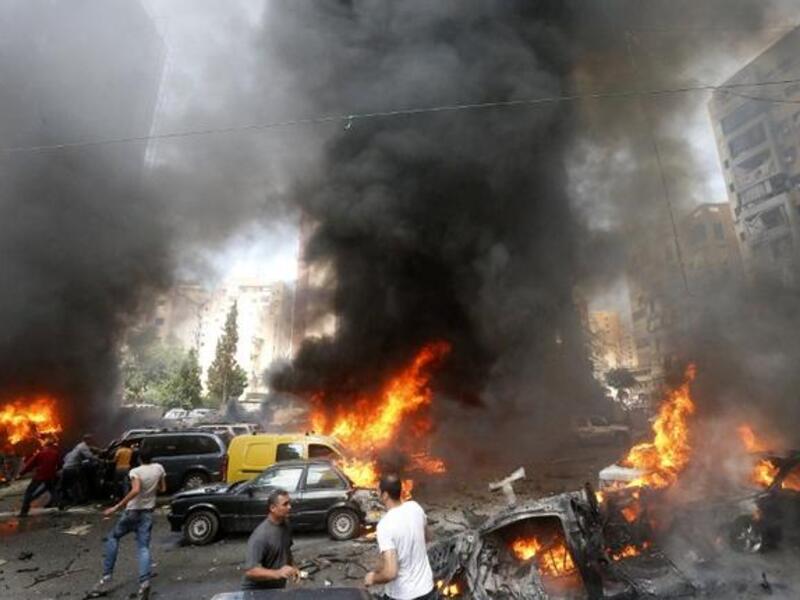 Civilians gather at the of an explosion in Beirut's southern suburb neighbourhood of Bir al-Abed on July 9 (AFP)