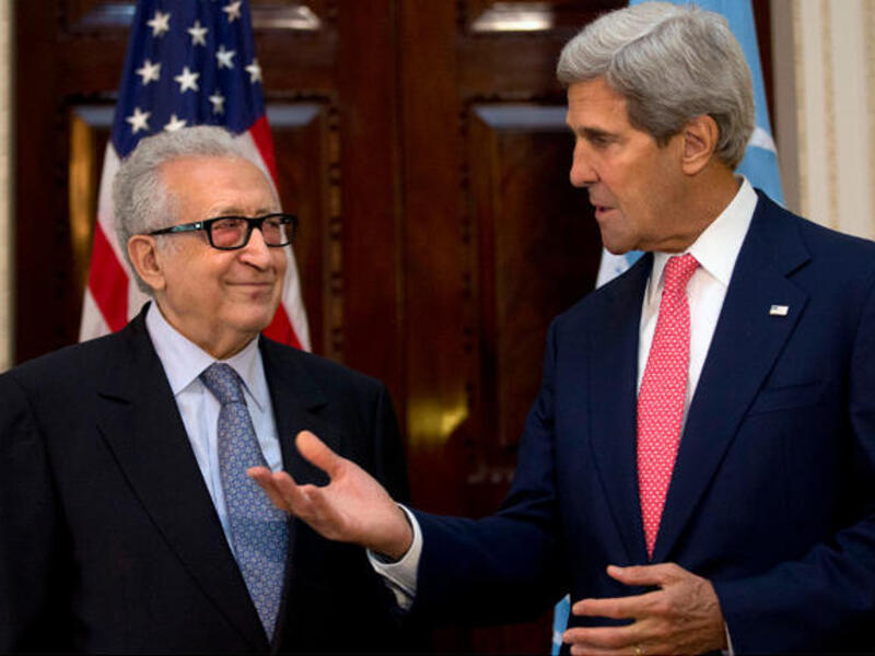 U.N-Arab League envoy for Syria Lakhdar Brahimi (L) listens as U.S. Secretary of State John Kerry speaks. (Image credit: AFP)