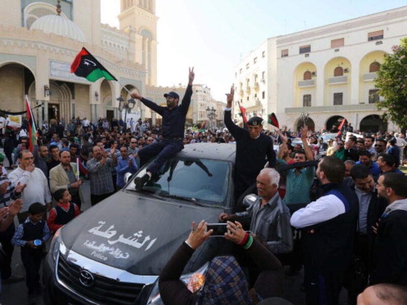 attend a demonstration alongside Libyan civilians in Tripoli against the presence of militia in the capital and in support of the army and police on November 19, 2013. [MAHMUD TURKIA/Getty Images]
