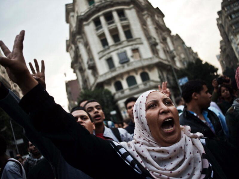 Egyptian Activists and members of the 6th of April movement shout slogans against the Egyptian Military on November 27, 2013, in Cairo. [Gianluigi Guercia/AFP]