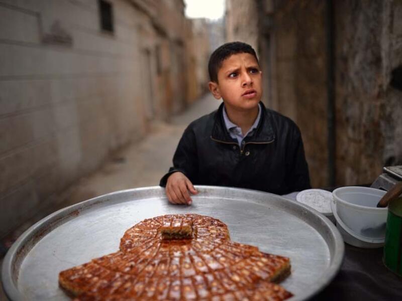 Similar to Omar, this Syrian boy is selling sweets on the streets of Aleppo. (AFP/File)
