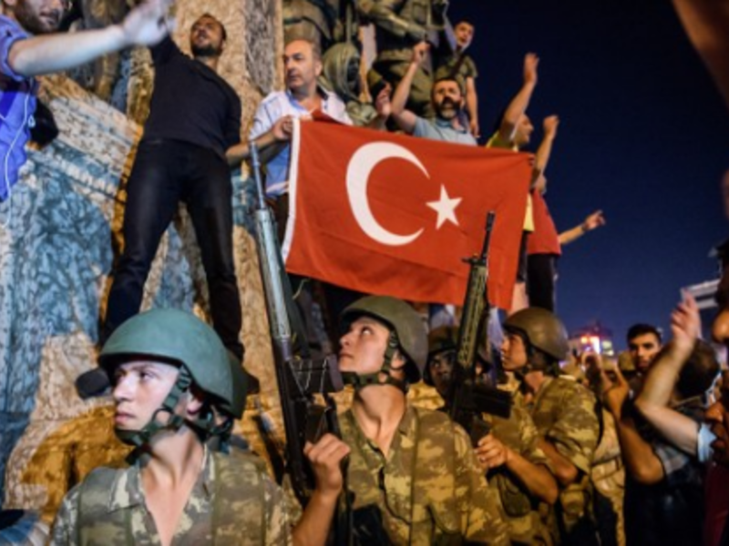 Turkish solders stay with weapons next to protesters in Istanbul on July 16, 2016. (AFP/Ozan Kose)