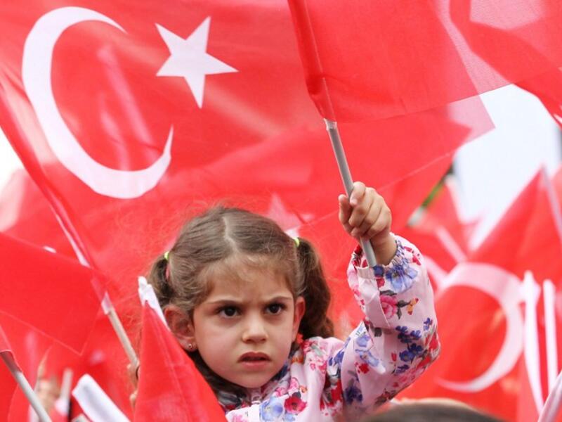 Supporters cheer Turkey's President Recep Tayyip Erdogan as he addresses an election rally in the Golbasi district of Ankara. (AFP PHOTO/ADEM ALTAN)