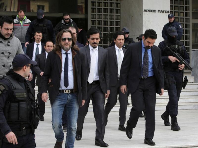 Turkish officers are escorted by Greek special police forces as they leave the Greek Supreme Court in Athens, after a hearing concerning a possible extradition of the officers over July's failed coup in Turkey, on January 23, 2017 in Athens. (AFP/Angelos Tzortzinis)